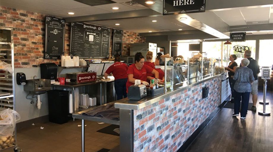 The inviting entrance of Grass Valley Sourdough & Co. showcasing a menu focused on the best sandwiches, soups, and salads