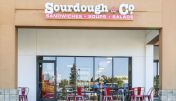 The inviting entrance of Auburn's Sourdough & Co. Store showcasing a menu focused on the best sandwiches, soups, and salads