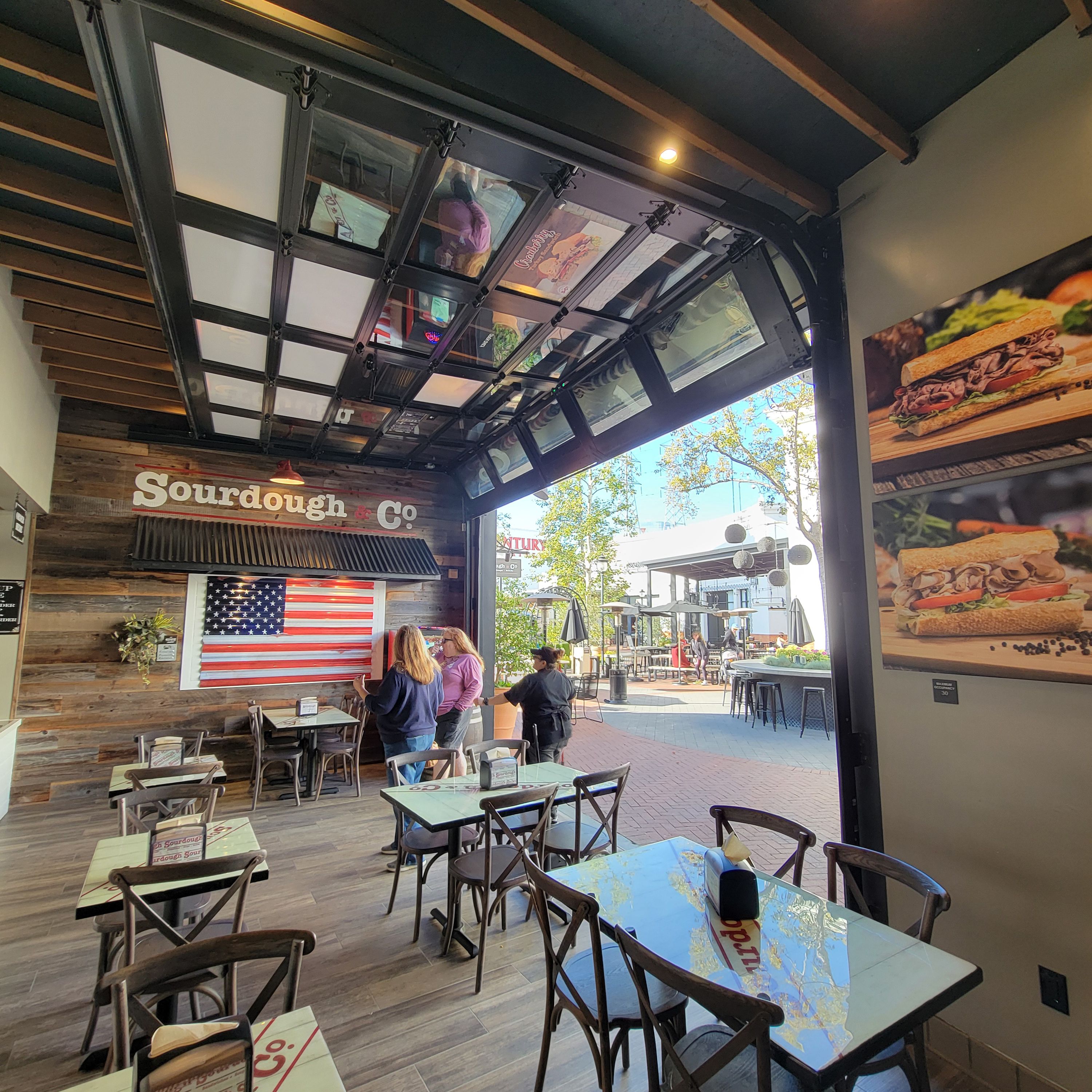 The inviting entrance of Huntington Beach (Inside Bella Tera Mall) Sourdough & Co.) showcasing a menu focused on the best sandwiches, soups, and salads