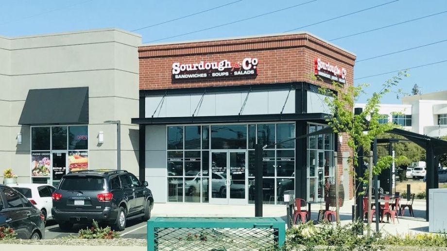 The inviting entrance of Sacramento Bicentennial Circle Sourdough & Co. showcasing a menu focused on the best sandwiches, soups, and salads