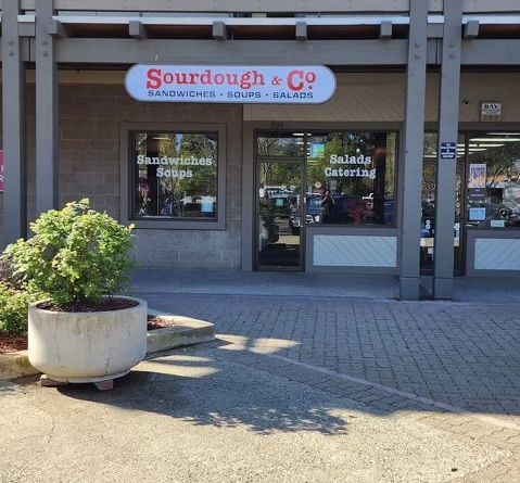 The inviting entrance of Pleasant Hill Sourdough & Co. showcasing a menu focused on the best sandwiches, soups, and salads