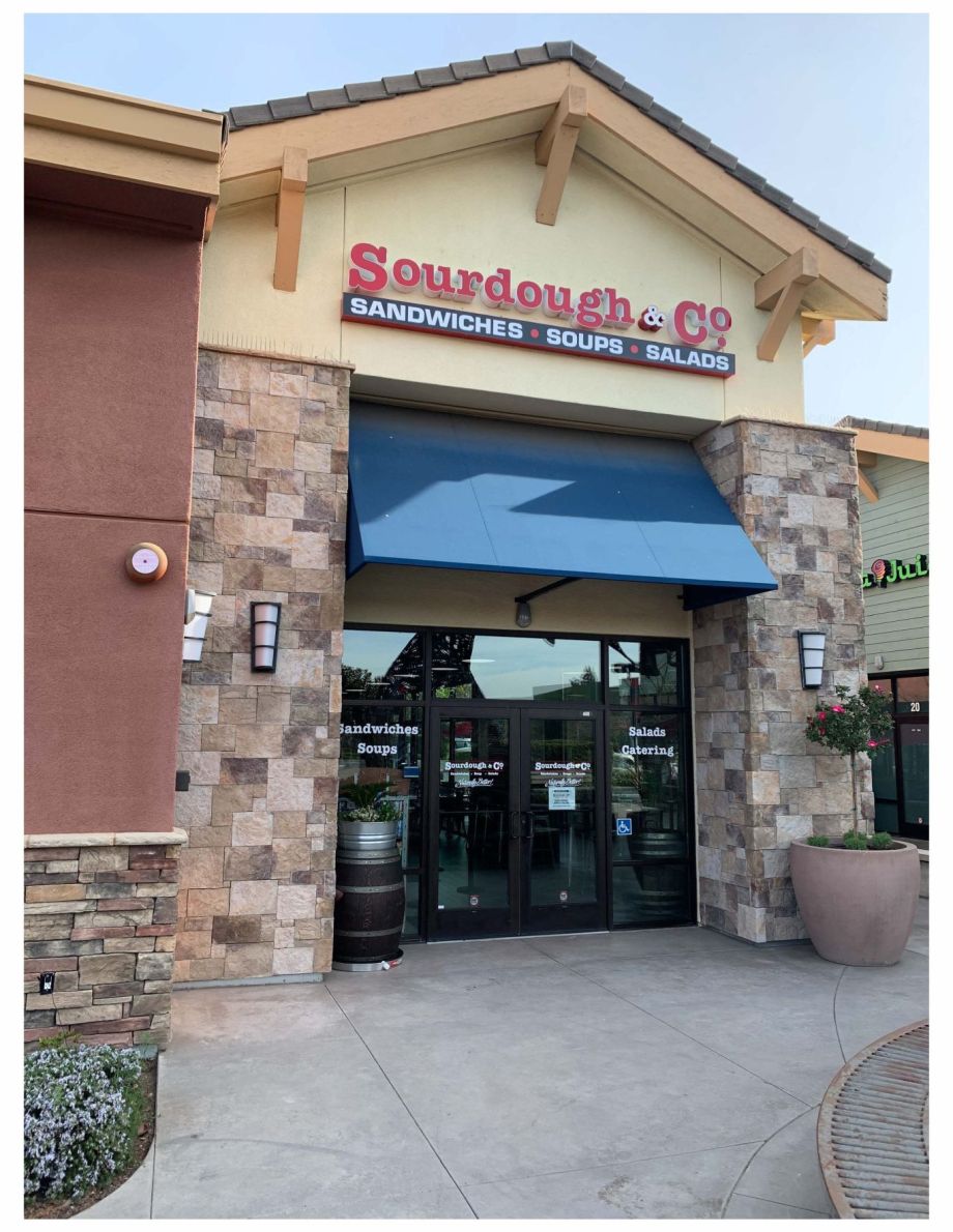 The inviting entrance of Petaluma Sourdough & Co. showcasing a menu focused on the best sandwiches, soups, and salads