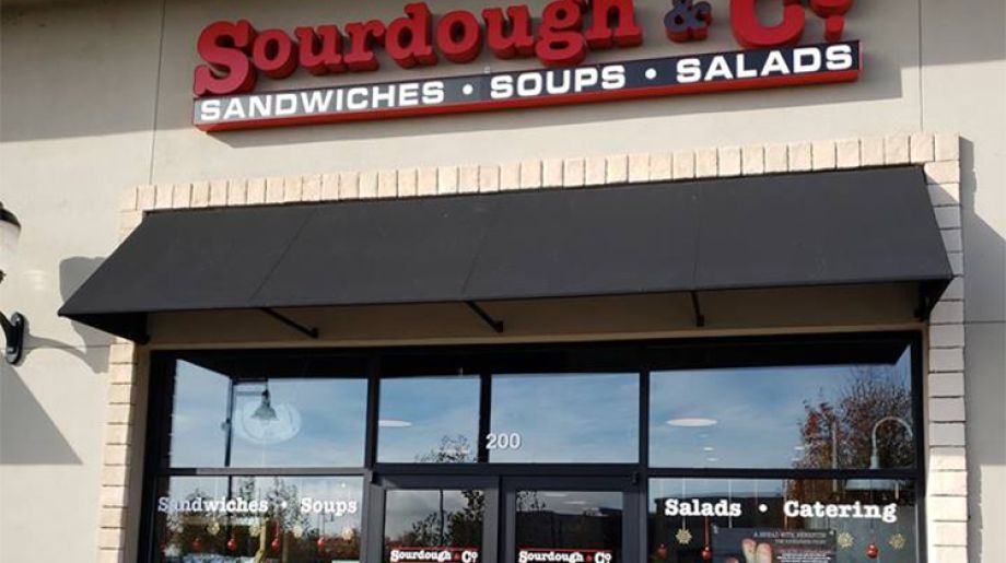 The inviting entrance of Woodland Sourdough & Co. showcasing a menu focused on the best sandwiches, soups, and salads