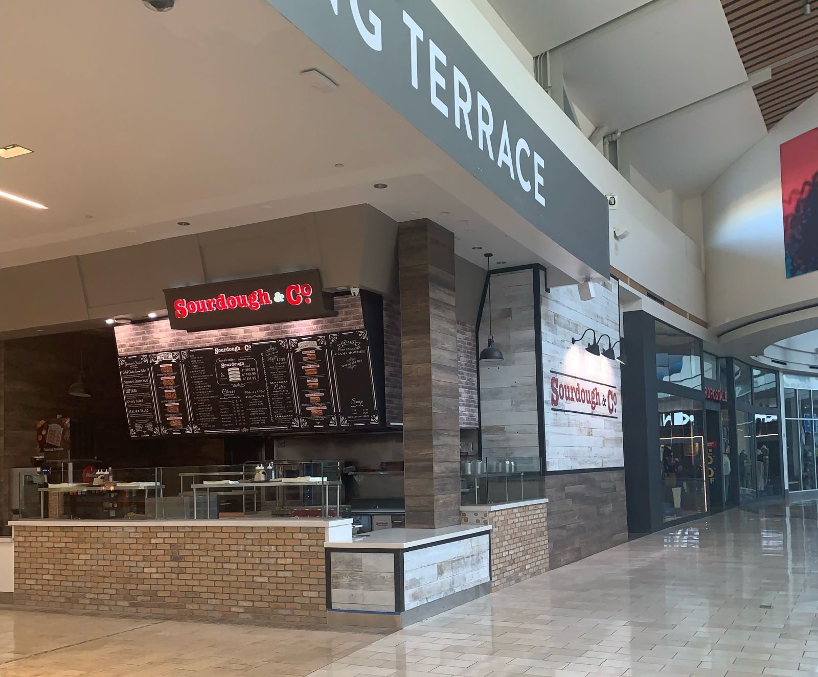 The inviting entrance of Roseville Galleria Blvd Sourdough & Co. showcasing a menu focused on the best sandwiches, soups, and salads