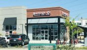 The inviting entrance of Sacramento Bicentennial Circle Sourdough & Co. showcasing a menu focused on the best sandwiches, soups, and salads