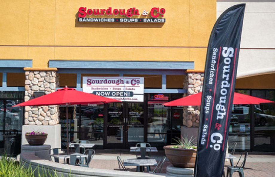 The inviting entrance of Folsom Iron Point Sourdough & Co. showcasing a menu focused on the best sandwiches, soups, and salads